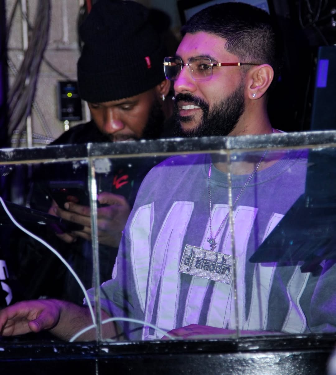 DJ Aladdinn in the DJ booth working the decks at a club