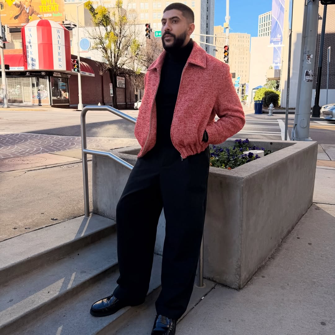 DJ Aladdinn in a red jacket on a downtown Atlanta street during the day